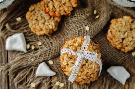 Oatmeal coconut cookies on a wood background. toning. selective focusの写真素材