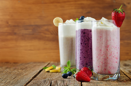 set of milkshakes: banana, strawberry and blueberry. toning. selective Focusの写真素材