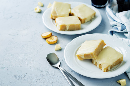 White chocolate banana bars on a grey background. toning. selective focusの写真素材