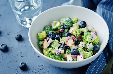 Broccoli blueberry apple salad with greek yogurt poppy seeds dressing. toning. selective focusの写真素材