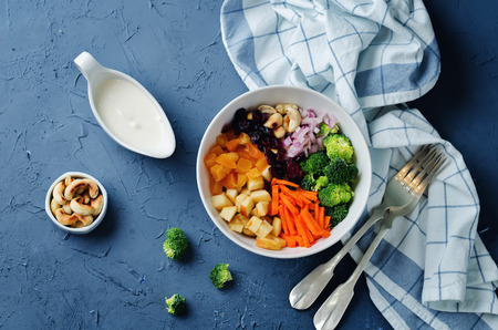 Broccoli carrot cashews apple salad with honey greek yogurt dressing. toning. selective focusの写真素材