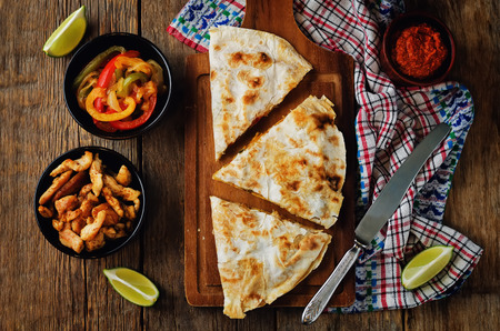 Chicken Bell pepper quesadilla on a wood background. toning. selective focusの写真素材