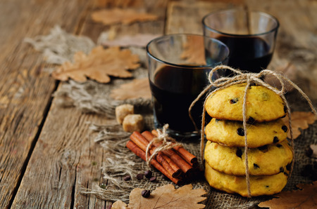 Chocolate chips pumpkin cookies with glass of coffee on a wood background. toning. selective focusの写真素材
