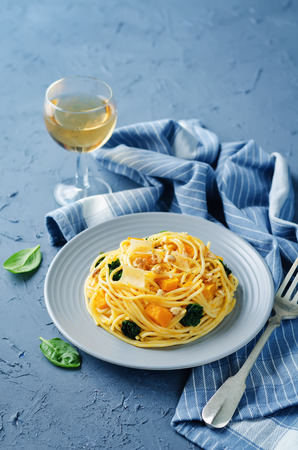 Pasta with pumpkin, spinach and walnuts. toning. selective focusの写真素材
