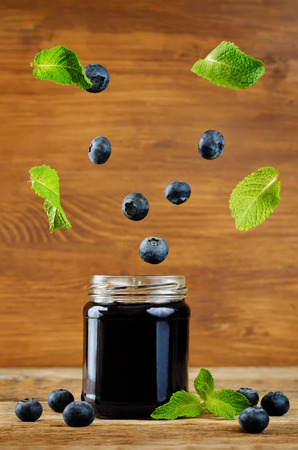 blueberry jam with flying mint and fresh blueberries. toning. selective Focusの写真素材