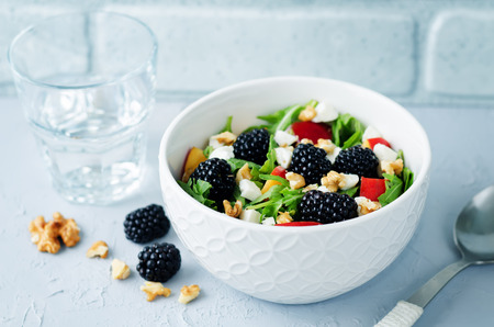 Arugula peach blackberry goat cheese salad. toning. selective focusの写真素材