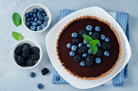 Chocolate tart with blackberries and blueberries. toning. selective focusの写真素材