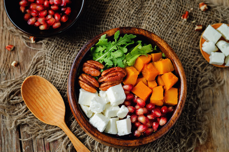 Pumpkin pomegranate pecan arugula goat cheese salad. toning. selective focusの写真素材