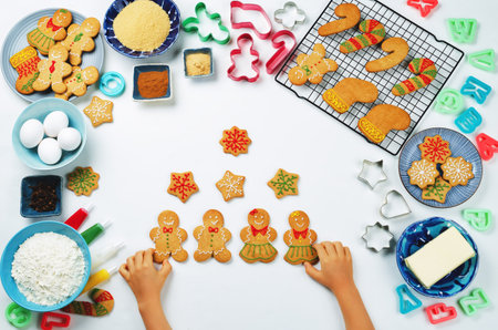 Gingerbread cookies with ingredients for baking and kids hands. toning. selective focusの写真素材