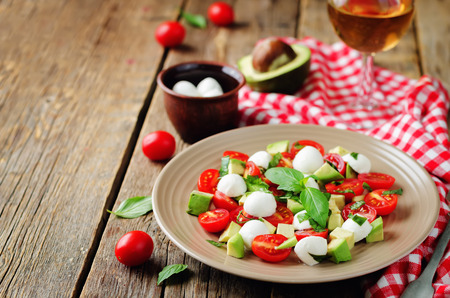 Avocado mozzarella tomato Basil salad. toning. selective focusの写真素材