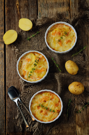 Pumpkin potato gratin on a wood background. toning. selective focusの写真素材