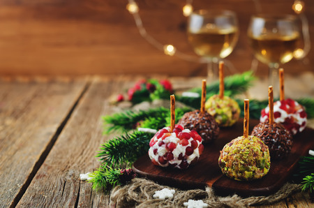 Variation of goat cheese balls appetizer with pistachio, pomegranate and flax seeds. toning. selective focusの写真素材