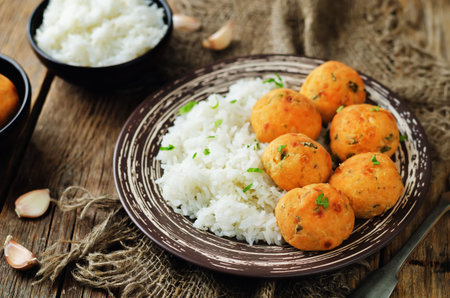 Salmon baked balls with rice on a wood background. toning. selective focus