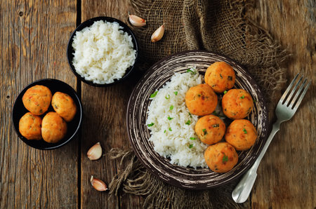 Salmon baked balls with rice on a wood background. toning. selective focus