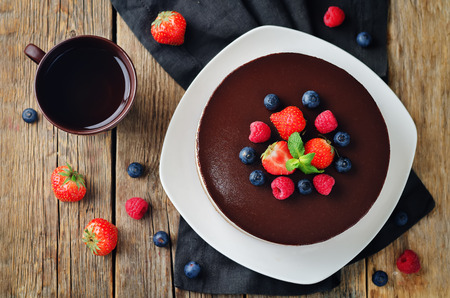 Triple chocolate mousse cake decorated with fresh berries. toning. selective focusの写真素材