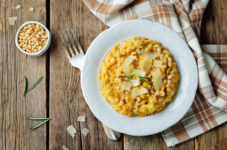 Roasted pumpkin and Pearl Barley Risotto on a wood background. toning. selective focusの写真素材