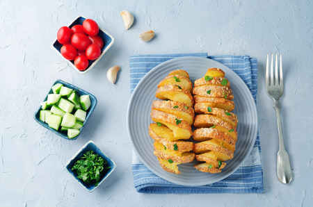 Tornado Cheesy Potatoes with Parsley on a stone background. toning. selective focusの写真素材