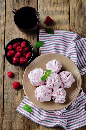 Raspberry Zephyr on a plate with fresh raspberries and mint on a wood background. toning. selective focusの写真素材