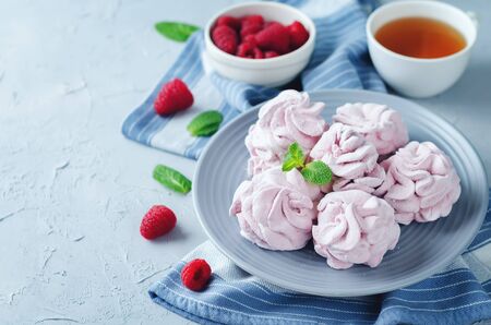 Raspberry Zephyr on a plate with fresh raspberries and mint on a stone background. toning. selective focusの写真素材
