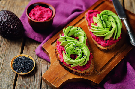 Healthy beet hummus avocado rye breakfast sandwiches. toning. selective focusの写真素材