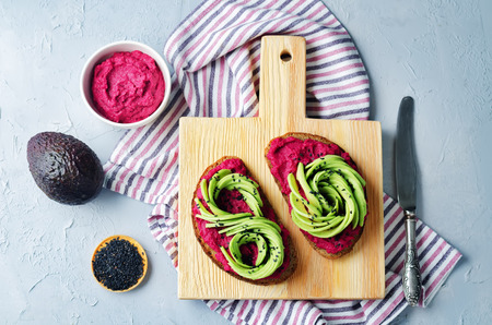 Healthy beet hummus avocado rye breakfast sandwiches. toning. selective focusの写真素材
