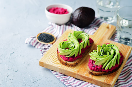 Healthy beet hummus avocado rye breakfast sandwiches. toning. selective focusの写真素材
