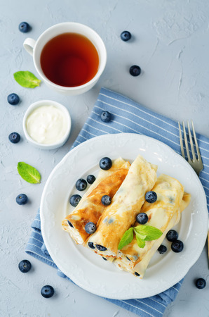 Sauteed Cream cheese Blueberry Crepes on a stone background. toning. selective focusの写真素材