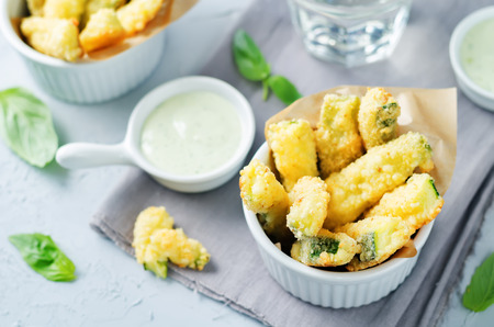 Baked Zucchini Fries with Pesto Greek yogurt sauce on a stone background. toning. selective focusの写真素材