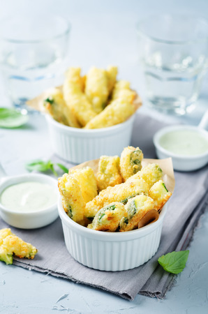 Baked Zucchini Fries with Pesto Greek yogurt sauce on a stone background. toning. selective focusの写真素材
