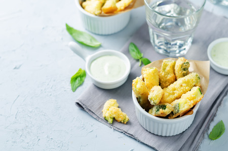 Baked Zucchini Fries with Pesto Greek yogurt sauce on a stone background. toning. selective focusの写真素材