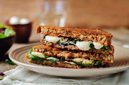 Fresh green mozzarella grilled rye sandwich on a dark woody background. toning. selective focusの写真素材
