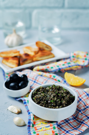 Black Olive Tapenade with roasted pita on a stone background. toning. selective focusの写真素材