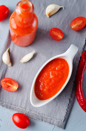 Roasted Red Pepper Tomato Garlic Sauce on a stone background. toning. selective focusの写真素材