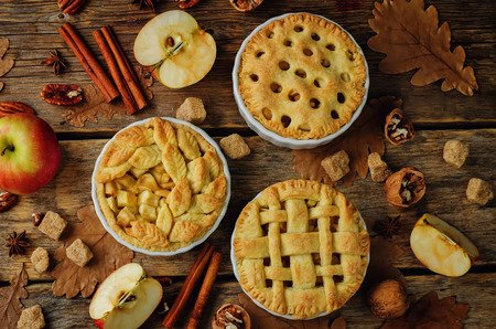Apple pies with different design on a wood background. tonung. selective focusの写真素材