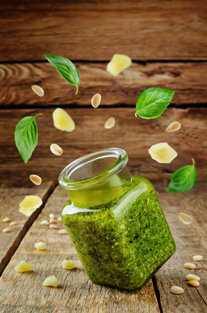 Pesto sauce with flying ingredients to prepare it. toning. selective focusの写真素材