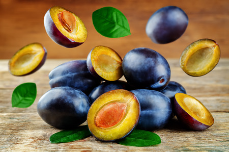 Flying Plums fruits on a woodの写真素材