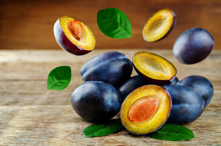 Flying Plums fruits on a woodの写真素材