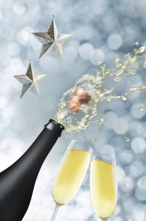 Bottle of champagne with a flying cork and spray. toning. selective focusの写真素材