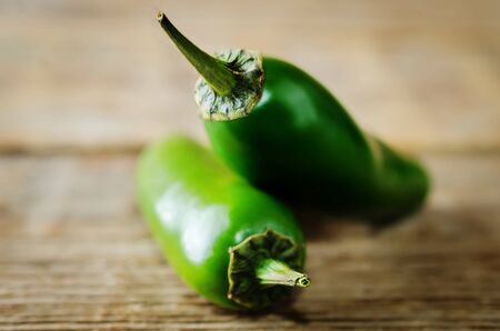 Fresh jalapeno peppers on a dark wood background. toning. selective focusの写真素材