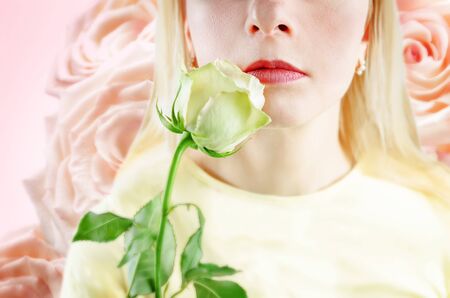 Beautiful young woman with a flower. toning. selective focusの写真素材
