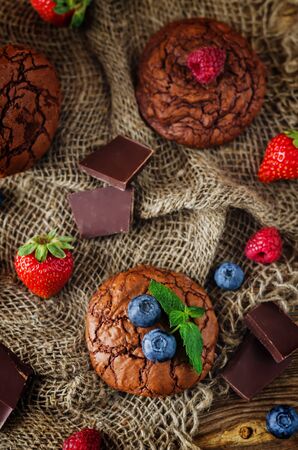 Chocolate brownie cookies with berries and mint leaves. the toning. selective focusの写真素材