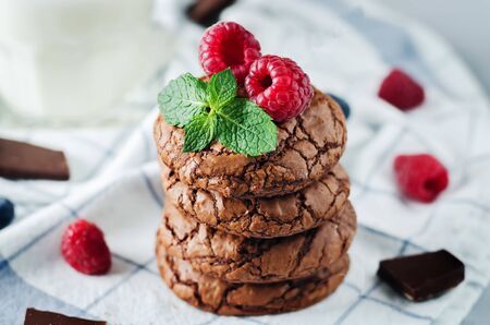 Chocolate brownie cookies with berries and mint leaves. the toning. selective focusの写真素材