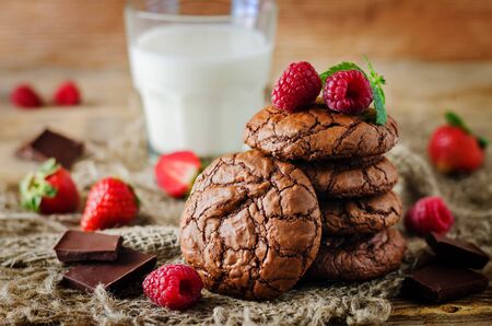Chocolate brownie cookies with berries and mint leaves. the toning. selective focusの写真素材