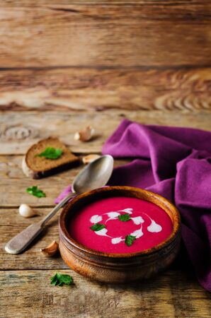 Beet soup with cream and parsley leaves. toning. selective focusの写真素材