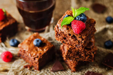 Chocolate brownie with berries and mint leaves. the toning. selective focusの写真素材