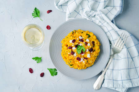 Pumpkin risotto with dried cranberries and goat cheese. toning. selective focusの写真素材