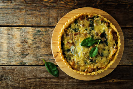 bacon spinach quiche with fresh spinach leaves. toning. selective focusの写真素材