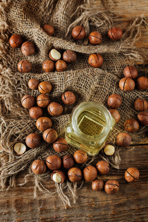 macadamia oil in glass with macadamia nuts. toning. selective focusの写真素材