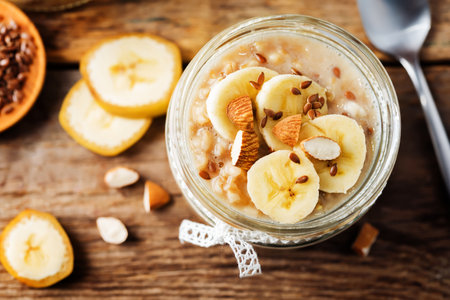 Banana flax seeds overnight oats with banana slices and almonds. toning. selective focusの写真素材