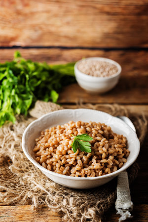 Barley porridge decorated with parsley leaves. toning. selective focusの写真素材